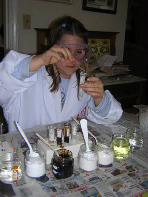 photo of girl in lab coat mixing chemicals